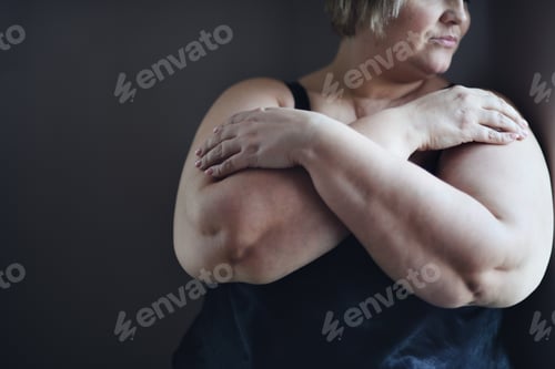 Preview: Depressed fat woman standing with arms crossed and looking through the window at home, cut out