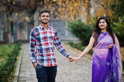 Preview: Stylish indian hindu couple posed on street.