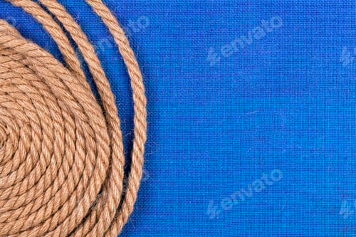 Preview: Ship rope on blue background, top view with copy space