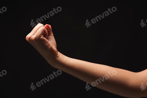 Preview: Female Hand Clenched Fist On Black Isolated Background, Low Key, Cutout