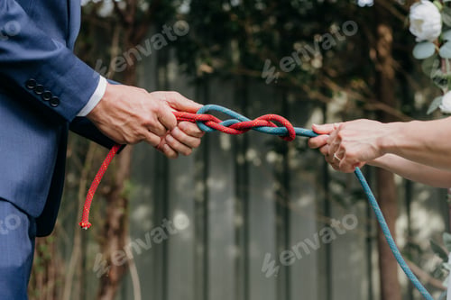 Preview: a woman pulling on the ends of a rope, holding her hands