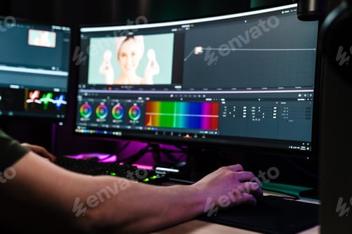 Preview: Back view of a young white man video editor