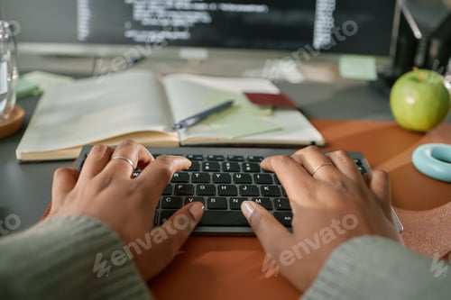 Preview: Young Adult Black Woman Typing on Wireless Keyboard While Working at Desk