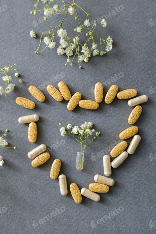 Preview: Pills and vitamins on yellow background