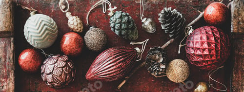 Preview: Flat-lay of Christmas decorative toys over red wooden background, close-up