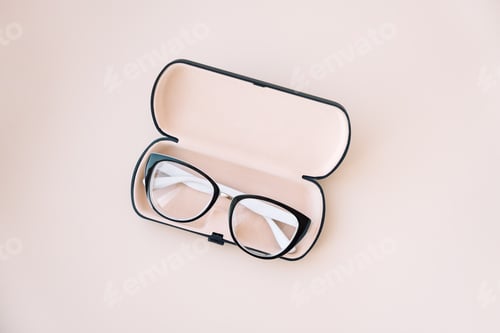 Preview: Eyeglasses with black frames in a light case