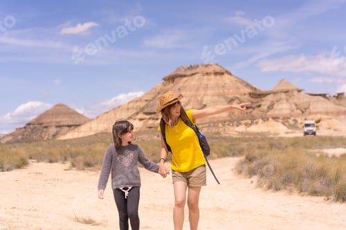 Preview: Mother and daughter holding hands strolling for a national park