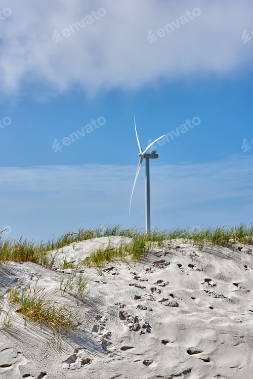 Preview: Wind turbine, blue sky and beach with sand for renewable energy, alternative power or natural susta