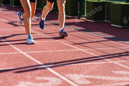 Preview: Runners legs jogging on a treadmill rubber stadium on sunny summer day. Sporty training cardio