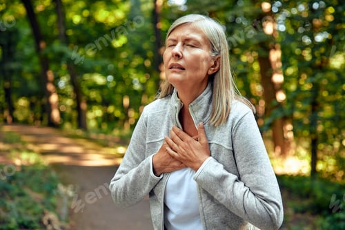 Preview: A Woman Experiencing Discomfort and Unease While Being Outdoors in the Lush Greenery