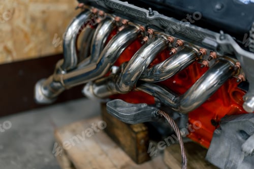 Preview: close-up at service station metal exhaust system several pipes converge into one down