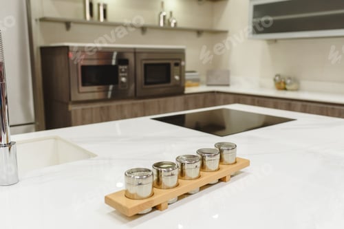 Preview: Saltcellers on a white marble table in a modern kitchen.