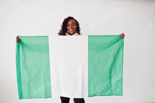 Preview: Nigerian woman hold Nigeria flag isolated on white wall.