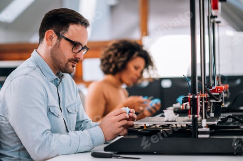Preview: Close-up portrait of an engineer working with 3D printer.