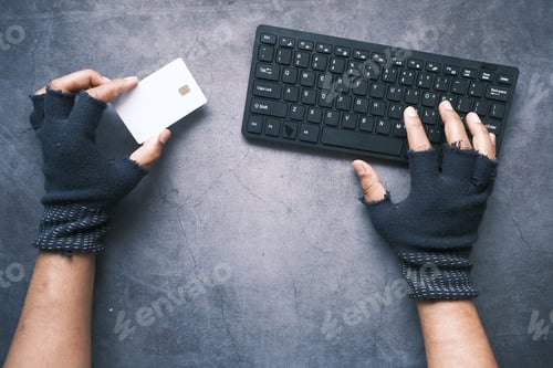 Preview: hacker hand stealing data from credit card