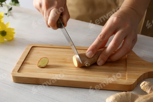 Preview: Cutting fresh ginger root on a cutting board