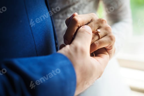 Preview: Newlywed Couple Holding Hands Together