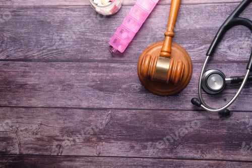 Preview: Top view of gavel and pills on wooden background