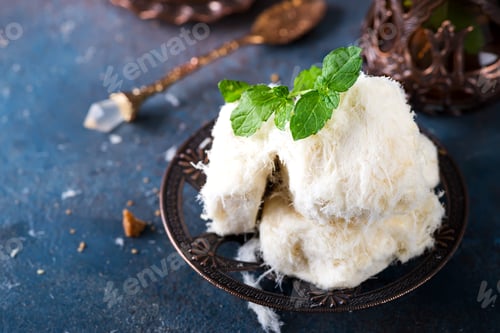 Preview: Traditional Turkish cotton candy Pismaniye in vintage plate with tea on stone background
