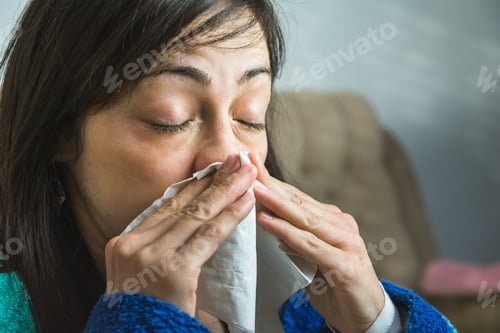 Preview: Woman about to sneeze holding a handkerchief in front of her face