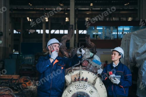 Preview: Team engineers are on duty and talking, looking at, and repairing the big machine.