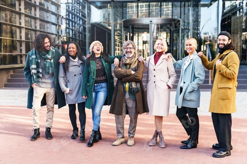 Preview: Happy team of positive international business friends smiling and laughing together