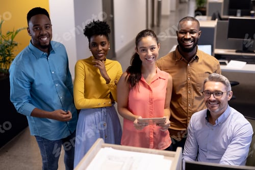 Preview: Portrait of happy biracial male and female advisors in meeting at modern workplace