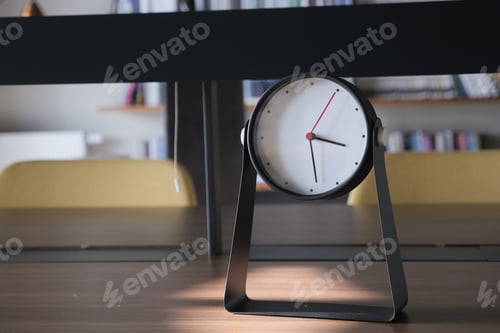 Preview: simple modern clock on a book shelf .