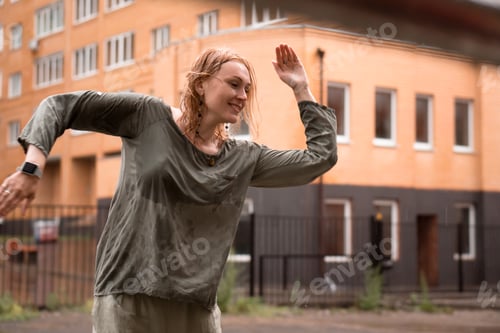 Preview: Dancing woman on the street under rain