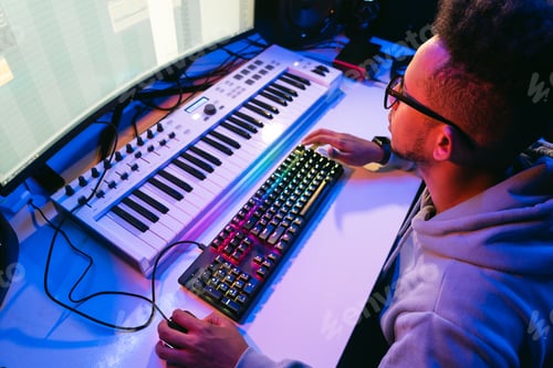Preview: Man working on computer in studio