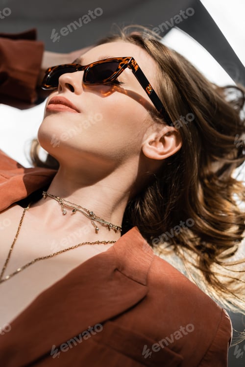 Preview: top view of pretty young woman with long hair and natural makeup wearing terracotta and trendy suit