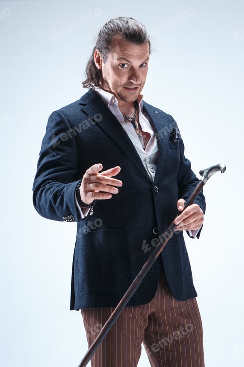 Preview: The Mature Barded Man In A Suit Holding Cane.