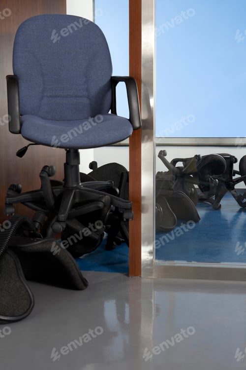 Preview: A grey office chair on top of fallen office chairs