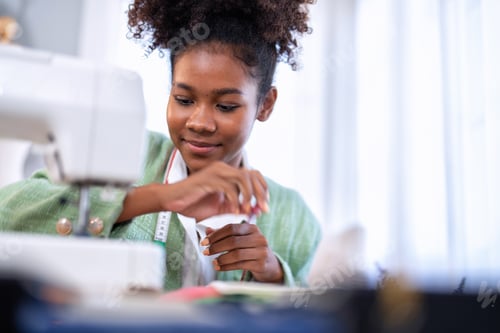 Preview: Stylish fashionable clothes designer girl at a sewing machine design clothes tailoring studio room