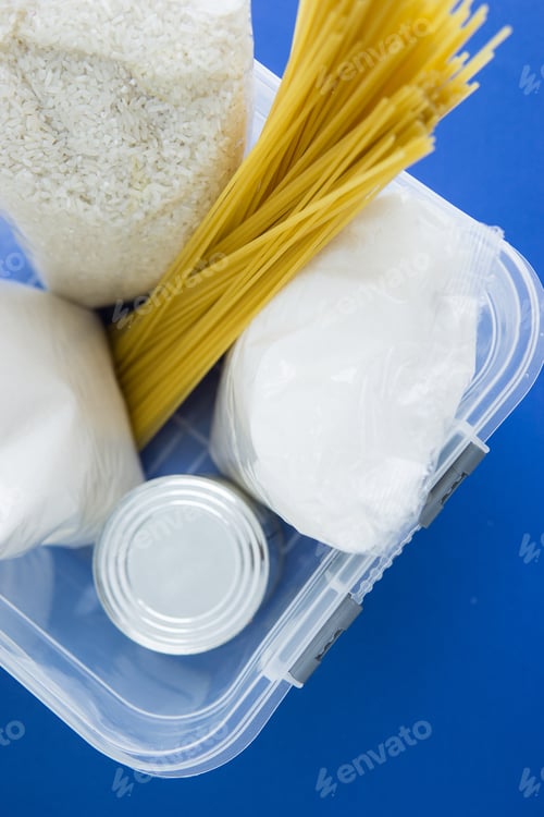 Preview: Food aid during quarantine. Container with products: sugar, rice, pasta, canned food.