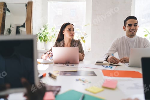 Preview: Happy colleagues with laptops working on startup