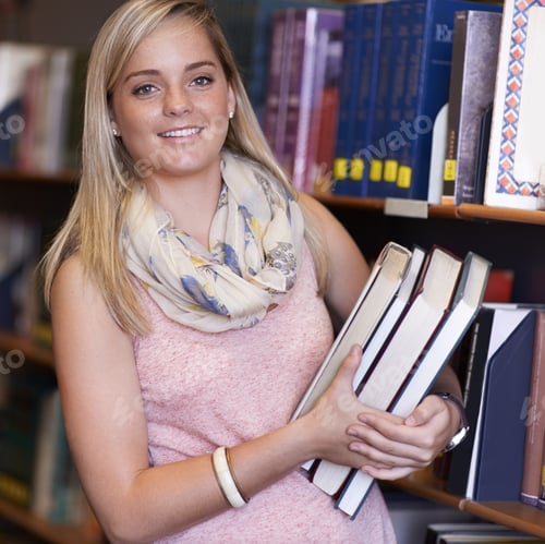 Preview: Shes a true bookworm. A young woman getting books from a library shelf.