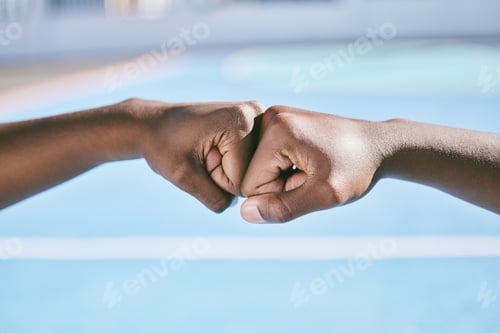 Preview: Closeup of hands, fist bump and the teamwork of two athletic, sporty, and active male athletes. Tea