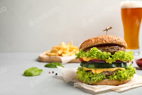 Preview: Tasty fresh burger on table. Space for text