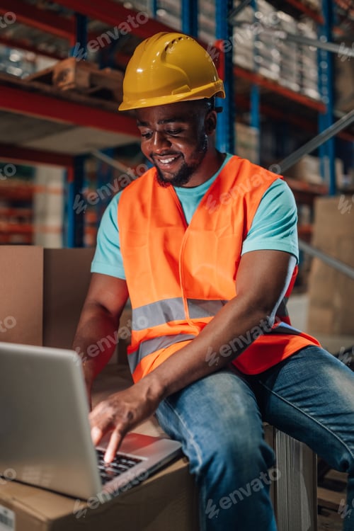 Preview: Warehouse worker using laptop for inventory management