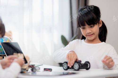 Preview: Two Asian students learn coding robot cars and electronic board cables in STEM,
