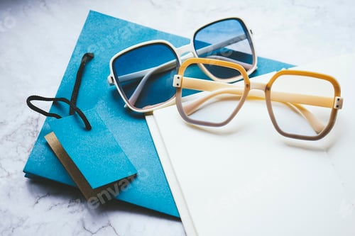 Preview: Stylish Sunglasses on a Notebook with Blue Paper