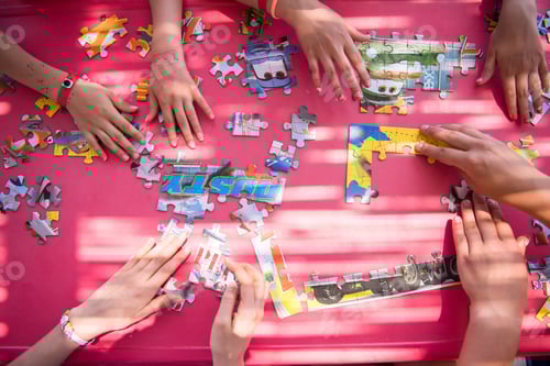Preview: top view of kids hands playing with puzzles