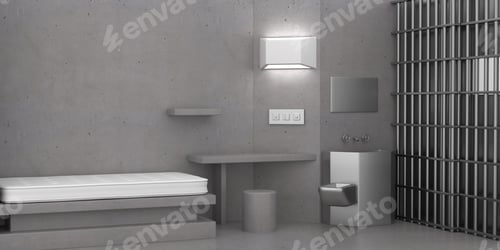 Grey, cold prison interior with a mattress and toilet