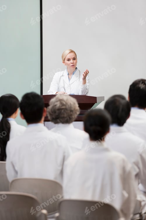 Preview: Female doctor giving speech in boardroom