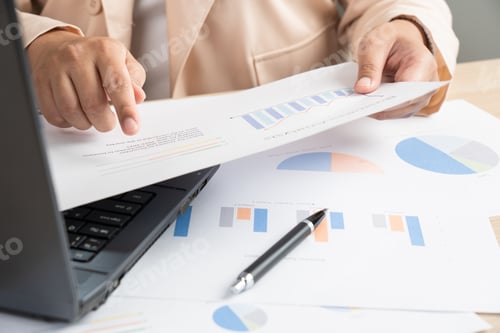 Preview: Business woman working for budget or report graph document paper on desk