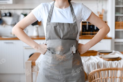 Preview: Woman gardener in grey apron with garden utensils in pockets. Ready to work
