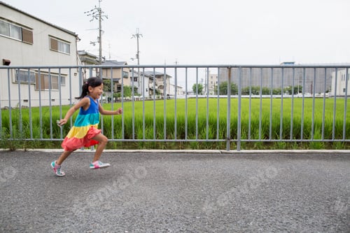 Preview: A young girl running along a footpath.