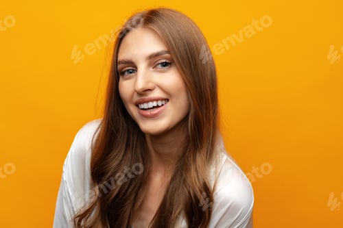 Preview: Pretty young woman smiling over yellow isolated background