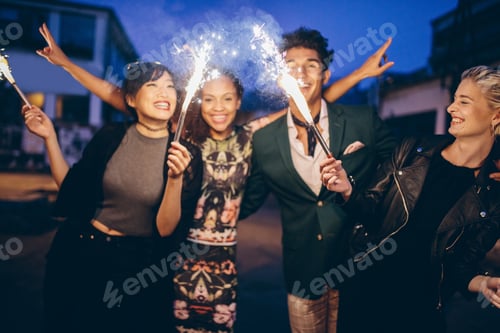 Preview: Young friends having night party with sparklers